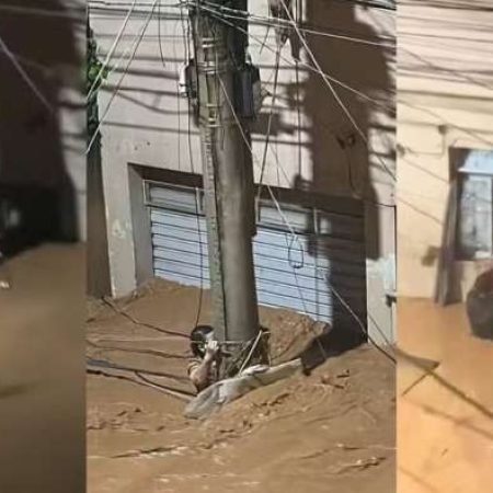 MULHER RESISTE POR 3H ABRAÇADA A POSTE EM ENXURRADA E É RESGATADA SOB APLAUSOS